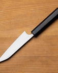 Knife with a black handle on a wooden surface
