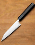 Knife with a black handle on a wooden surface