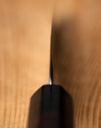 close up up knife blade on a wooden surface