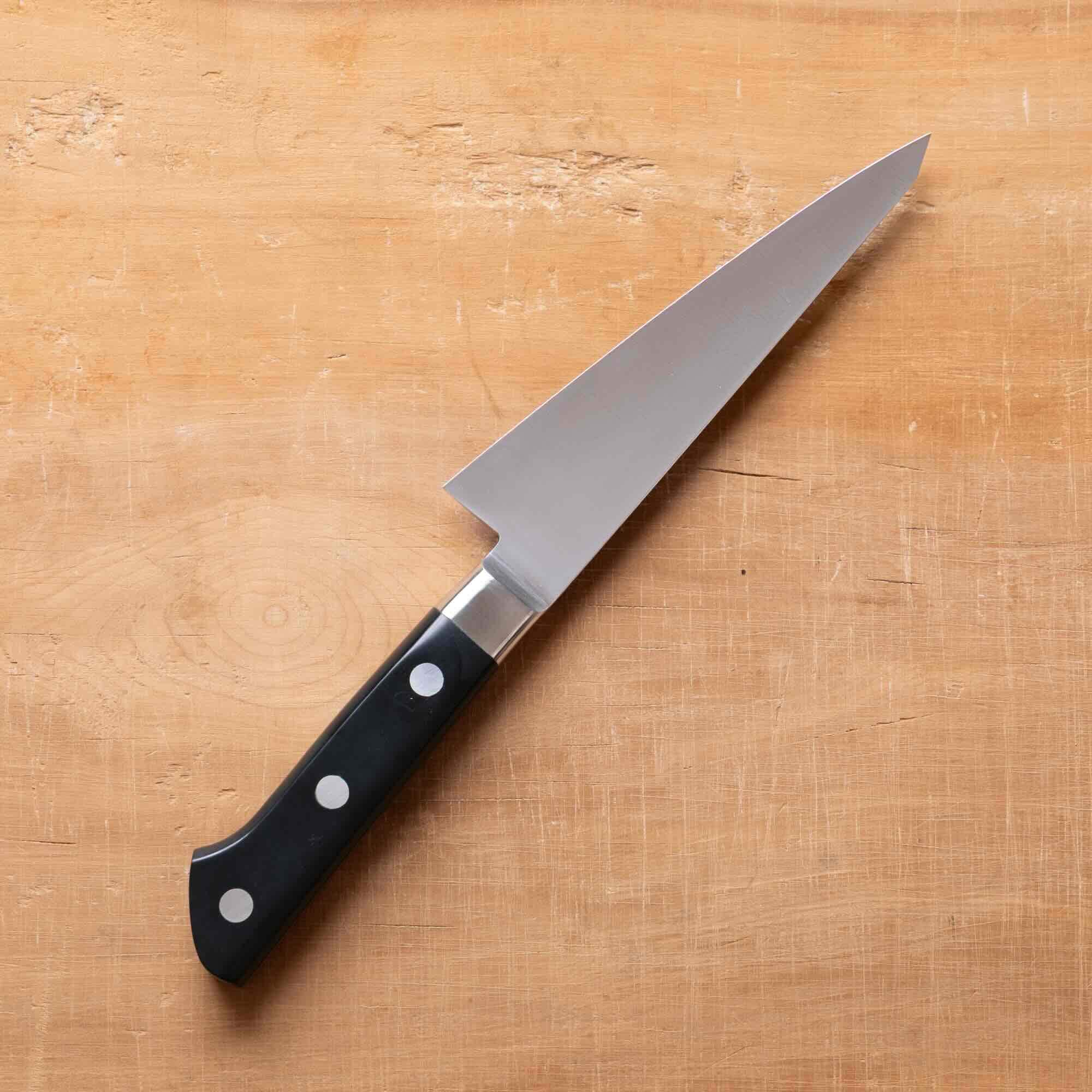 Knife with a black handle on a wooden surface