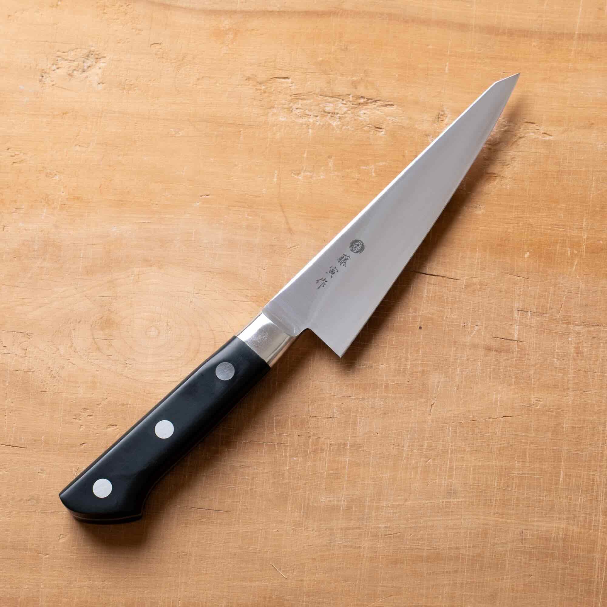 Knife with a black handle on a wooden surface